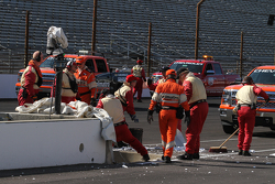 Workers replace the pitwall barrier after Pippa Mann's crash
