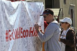 Fans sign a #GetWellHinch banner