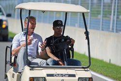 Lewis Hamilton, Mercedes AMG F1 drives the circuit with David Coulthard, Red Bull Racing and Scuderi