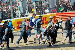 Fans invade the circuit at the end of the race.