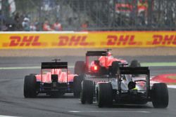 Will Stevens, Manor F1 Team and Roberto Merhi, Manor F1 Team lead Fernando Alonso, McLaren MP4-31