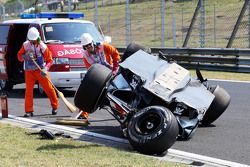 Safety crews tend to the crashed car of Sergio Perez, Sahara Force India F2