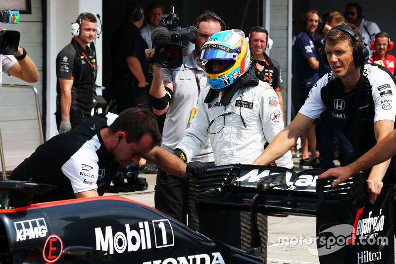 The McLaren MP4-30 of Fernando Alonso, McLaren is pushed into the pits during qualifying