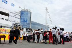 The drivers observe the tribute to Jules Bianchi on the grid