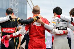 The drivers observe the tribute to Jules Bianchi on the grid