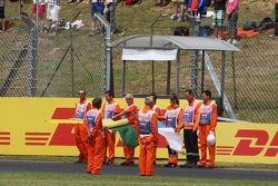 Marshals observe the pre-race tribute to Jules Bianchi