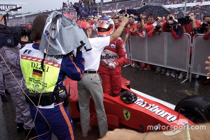 Michael Schumacher greets race winner Rubens Barrichello, Ferrari in parc ferme