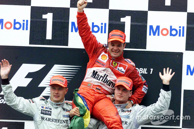 Podium: second place Mika Hakkinen, McLaren and winner Rubens Barrichello, Ferrari and third place D