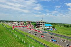 Cars line up on the grid for the start