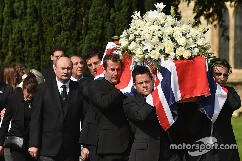 Mark Webber and Dario Franchitti help carry the casket of Justin Wilson during funeral proceedings