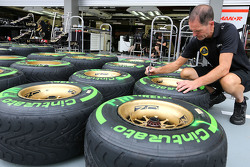 Lotus F1 Team mechanic with Pirelli tyres
