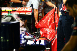 Pirelli engineers remove the damaged rear tyre of Carlos Sainz Jr., Scuderia Toro Rosso STR10 in the second practice session