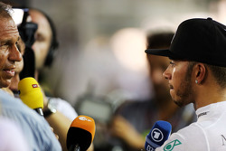 Lewis Hamilton (GBR) Mercedes AMG F1 with the media after he retired from the race