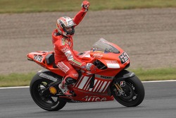 Race winner Loris Capirossi celebrates