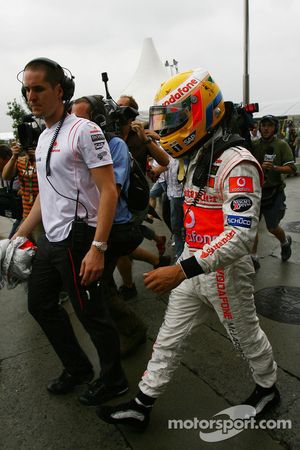 Lewis Hamilton, McLaren Mercedes, returns to the paddock after retiring from the race