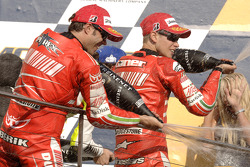Podium: champagne for Casey Stoner and Loris Capirossi