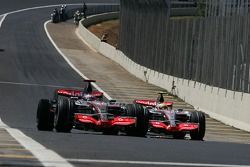 Fernando Alonso, McLaren Mercedes passes Lewis Hamilton, McLaren Mercedes rolls towards the pits