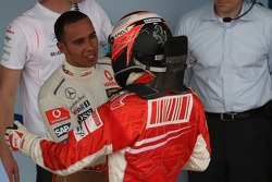 Race winner and 2007 World Champion Kimi Raikkonen congratulated by Lewis Hamilton