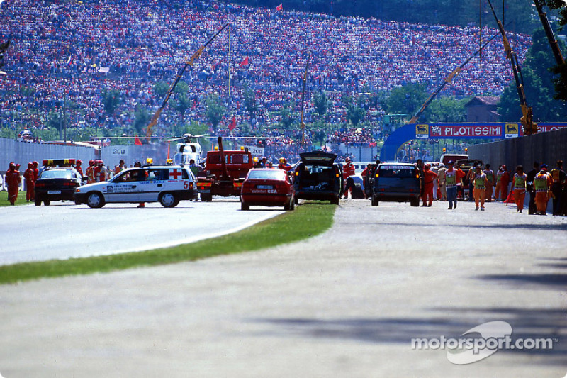 The fatal crash of Ayrton Senna at Tamburello: safety team members at work