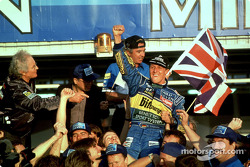 1995 Formula One World Champion Michael Schumacher celebrates with his team