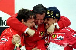 Podio: ganador de la carrera Michael Schumacher y Eddie Irvine de segundo lugar celebran con Jean To