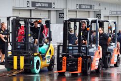 Lotus F1 Team mechanics with forklift trucks