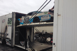 The burned hauler of Jimmy Means Racing carrying the car of Joey Gase