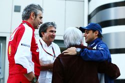 (L to R): Maurizio Arrivabene, Ferrari Team Principal with Pasquale Lattuneddu, of the FOM; Bernie E