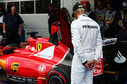 Lewis Hamilton, Mercedes AMG F1 looks at the Ferrari SF15-T of Sebastian Vettel, Ferrari in parc ferme