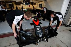 McLaren mechanics with a nose cone