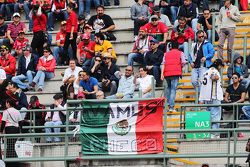 Fans in the grandstand and a Mexican flag