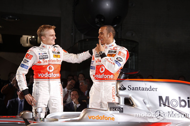 Heikki Kovalainen and Lewis Hamilton pose with the new McLaren Mercedes MP4-23