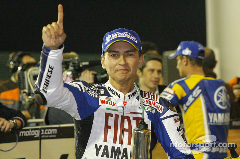 Pole winner Jorge Lorenzo celebrates with Juan Hernandez and Javier Ullate