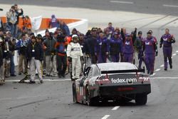 Race winner Denny Hamlin is greeted by his crew
