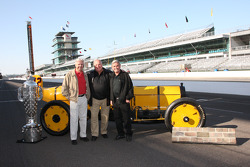 Rick Mears, A.J. Foyt and Al Unser Sr. pose with the Borg Warner trophy and the Marmon Wasp
