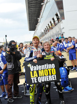 Race winner Valentino Rossi celebrates his 90th career victory with Angel Nieto