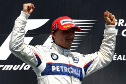 Podium: race winner Robert Kubica celebrates