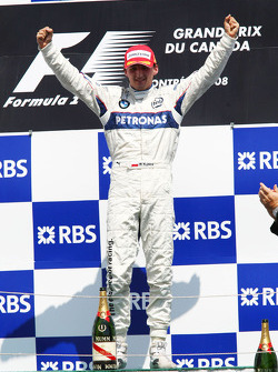 Podium: race winner Robert Kubica celebrates