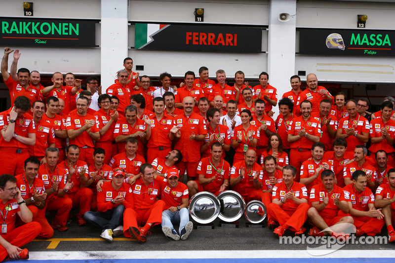 Race winner Felipe Massa celebrates with Kimi Raikkonen and Scuderia Ferrari team members