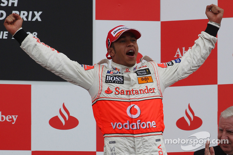 Podium: race winner Lewis Hamilton celebrates