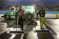 Crews dry the pitlane
