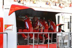 Ferrari team members on the pit wall