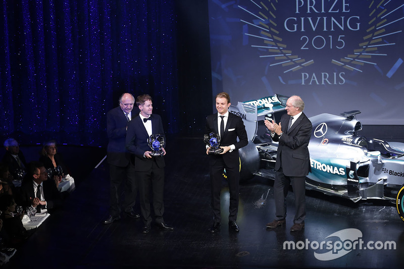 Nico Rosberg and Sebastian Vettel are handed their prizes for finishing second and third in the F1 drivers' standings.