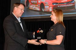 Erica Enders is given an award from General Motors Vice President Motorsports and Performance Vehicl