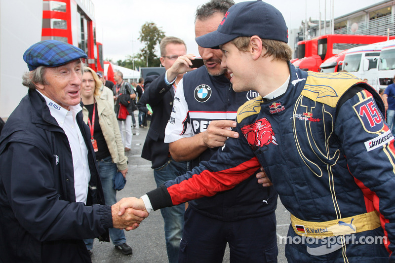 Pole winner Sebastian Vettel celebrates with Sir Jackie Stewart