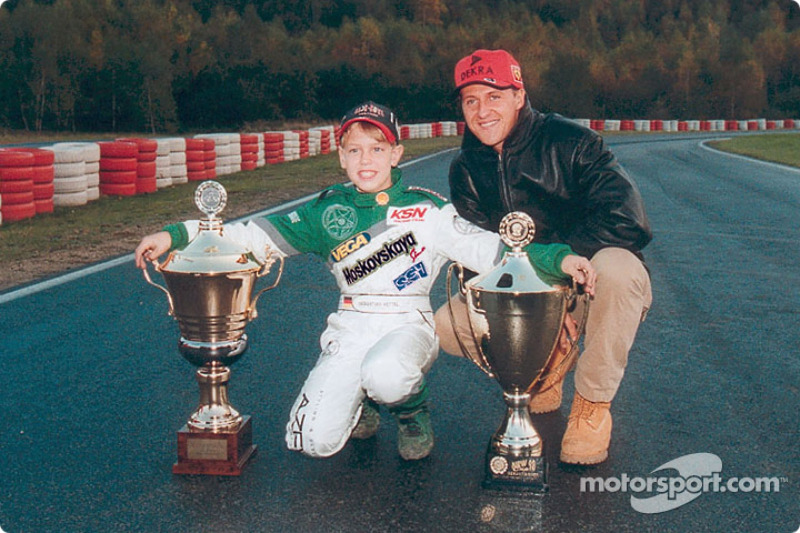 Young kart racer Sebastian Vettel poses with his hero Michael Schumacher