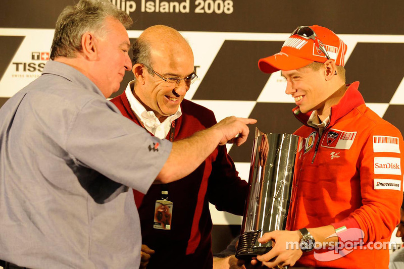 Casey Stoner receives his replica version of the premier-class trophy in recognition of his 2007 Wor