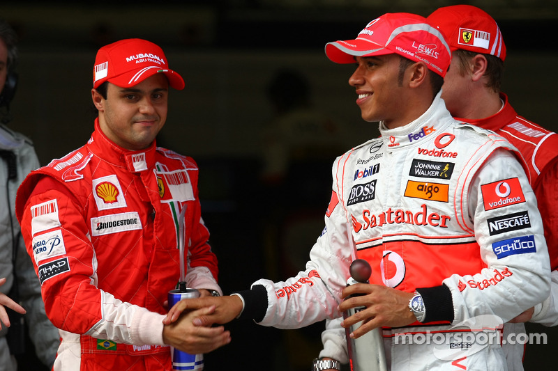 Pole winner Lewis Hamilton celebrates with Felipe Massa