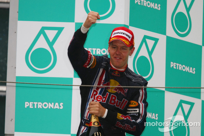 Podium: champagne for race winner Sebastian Vettel, Red Bull Racing