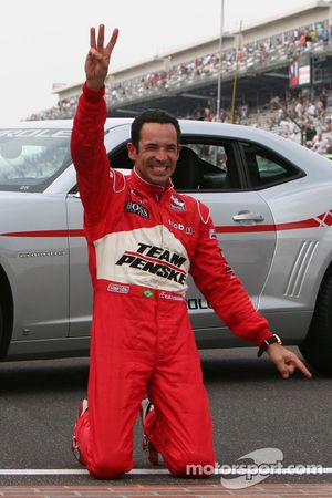 Race winner Helio Castroneves celebrates